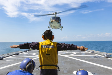 The helicopter is landing on a signal on warship © nattapon7