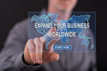 Man touching a worldwide business development concept on a touch screen