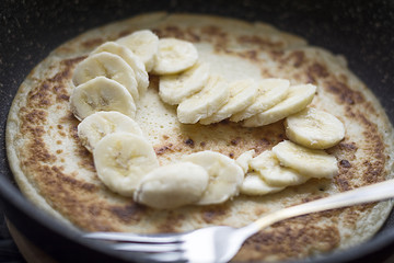 Hot delicious pancake with banana slices in a heart shaped. A perfect breakfast for Valentine's Day and all in love.