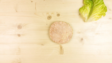 Making burger and chips on wooden background - top view
