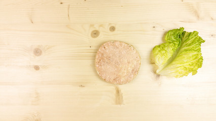 Making burger and chips on wooden background - top view