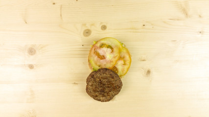 Fototapeta na wymiar Making burger and chips on wooden background - top view