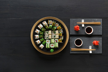 Set of sushi maki and rolls on black rustic wood, top view © Prostock-studio