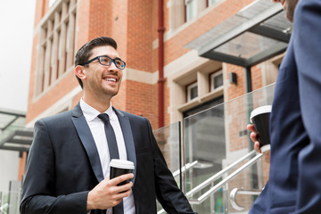 Two businessmen talking outdoors