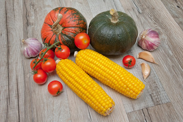 Vegetables lie on a wooden table.