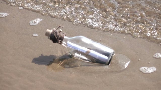 High quality video of message in the bottle on the beach in real 1080p slow motion 250fps.  More videos from this series in my portfolio
