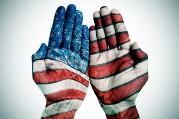 hands patterned with the US flag