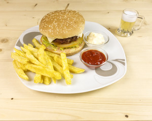Burger and chips on wooden background