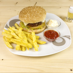 Burger and chips on wooden background