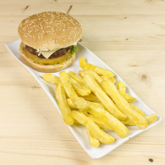 Burger and chips on wooden background