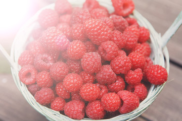 Basket with raspberries closeup, summer harvest