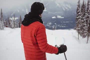 Skier standing on the top of the mountain