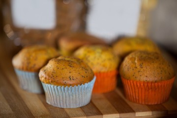 Close-up of cupcakes on wooden board