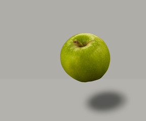 Apple floating on grey background