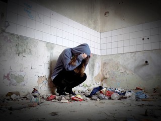 Sitting women in depression, young sadness women crying in old dirty abandoned house