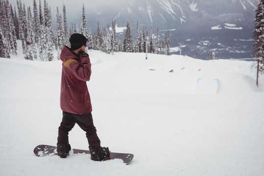 Man skiing on snowy alps in ski resort