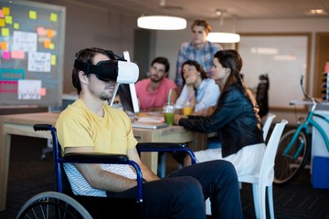 Naklejka premium Physically disabled man on wheelchair using VR headset