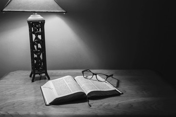 Open Holy Bible On Wood Table With Glasses