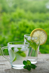 A cold drink made of lemon, lime and mint outdors