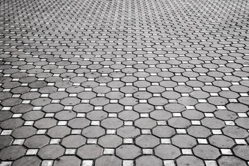 Cement brick floor background,patterned paving tiles.Brick paving stones on a sidewalk,black and white tone
