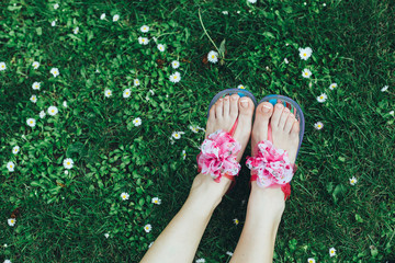 Woman's feet with flower sandals shot from above