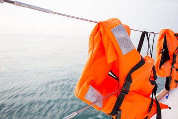 Life jacket hanging on a sea-side afternoon light boat.