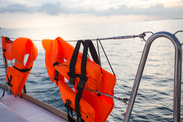 Life jacket hanging on a sea-side afternoon light boat.