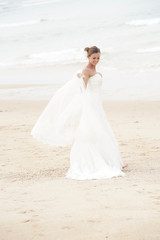 Fototapeta na wymiar Bride walking on a sandy beach