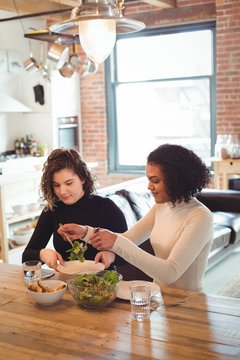 Lesbian couple preparing salad