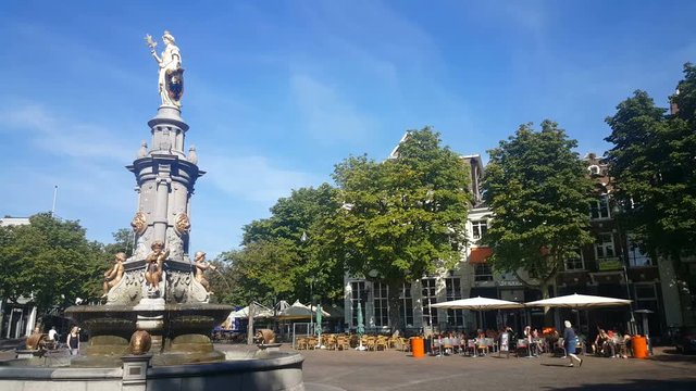 People walking on the Brink in Deventer, Wilhemina fountain