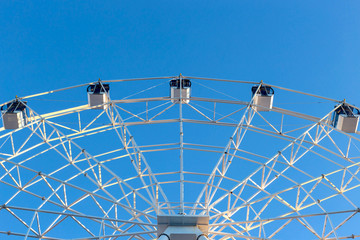 Ferris wheel against blue sky background