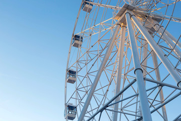 Ferris wheel against blue sky background
