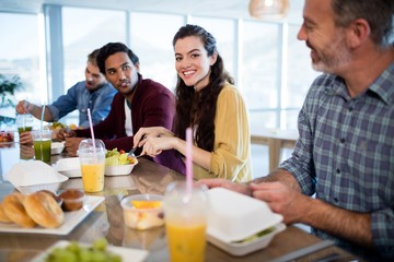 Creative business team having meal in office