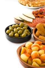 Traditional spanish tapas. Croquettes, olives,  ham and patatas bravas isolated on white background
