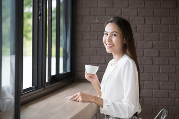 Asian beautiful women drinking coffee with attractive smile, 20-30 year old.