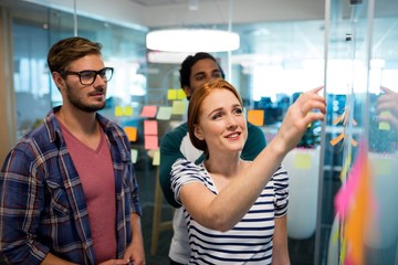 Creative business team reading sticky notes