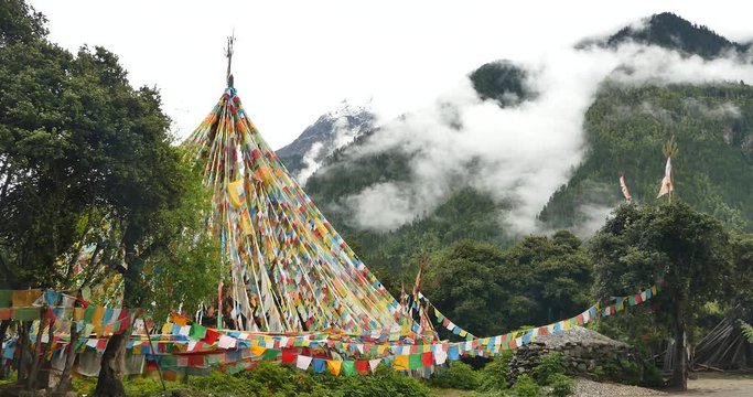 4k prayer flag with snow mountain in tibet.