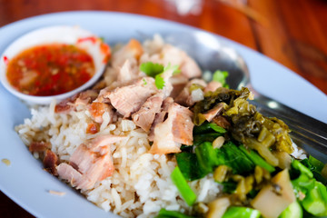 Stewed pork leg on rice dish on the table
