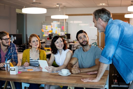 Creative business team discussing at desk