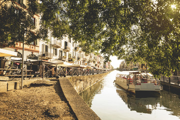 The Naviglio Grande canal waterway in Milan, Italy, at sunset. This district is famous for its...