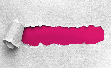 pink board texture under ripped paper 