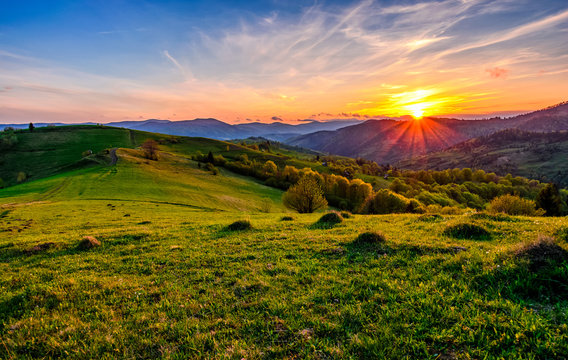mountain rural area in springtime at cloudy sunset
