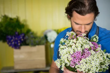 Photo sur Plexiglas Fleuriste Fleuriste tenant un bouquet de fleurs dans une boutique de fleuriste