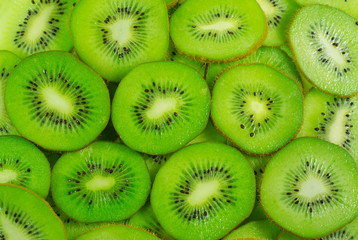 Many kiwi fruit slices background.