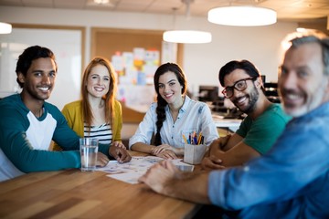 Smiling creative business team sitting at the desk