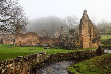 Fototapeta na wymiar Twelfth Century Fountains Abbey North Yorkshire on a misty day