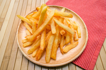  French fries on wood plate