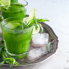 Refreshing drink made from fresh tarthun leaves with lime on white background, copy space