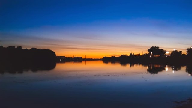 Time lapse of evening sky after sunset on Southern Bug river in Khmelnytskyi city, Ukraine