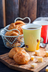 Buns with cheese from brewed dough on a wooden board, selective focus